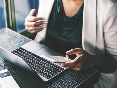 Woman with phone and laptop